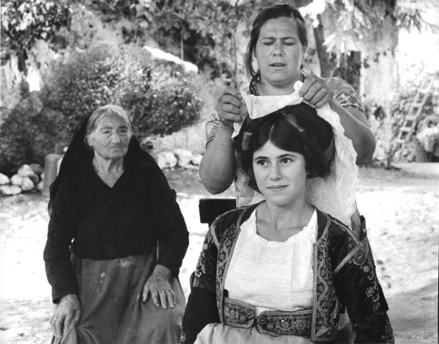 Angeliki putting on her national costume with  Katerina & Yaya's help